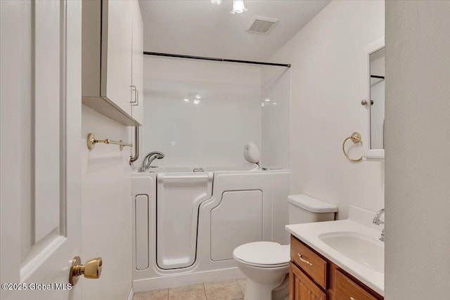 bathroom with tile patterned floors, vanity, toilet, and visible vents