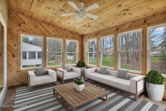 sunroom featuring wood ceiling, vaulted ceiling, wood walls, and wood finished floors