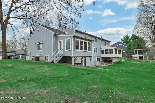 back of property with a yard, central AC, and a sunroom