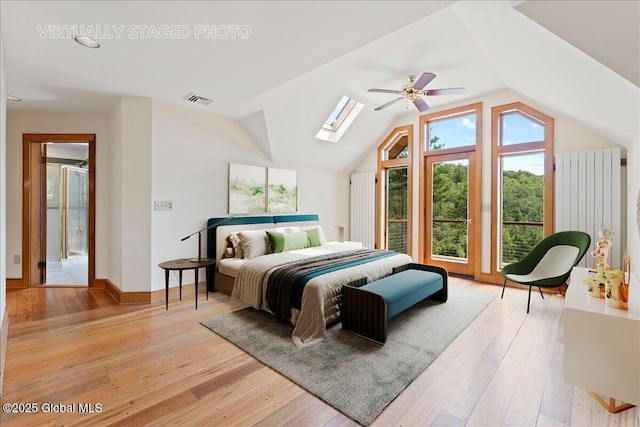 165 Vaughn Hill Rd, Middleburgh, NY 12122 - bedroom with light wood-style flooring, a skylight, vaulted ceiling, and access to outside