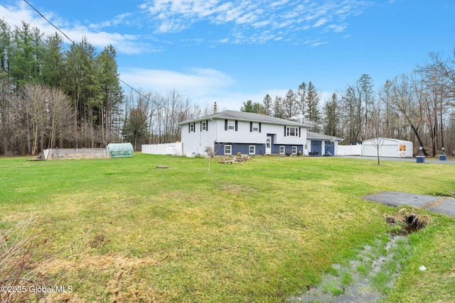 exterior space featuring a front lawn, fence, and a chimney