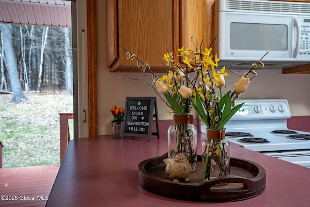 interior details with brown cabinets and white microwave