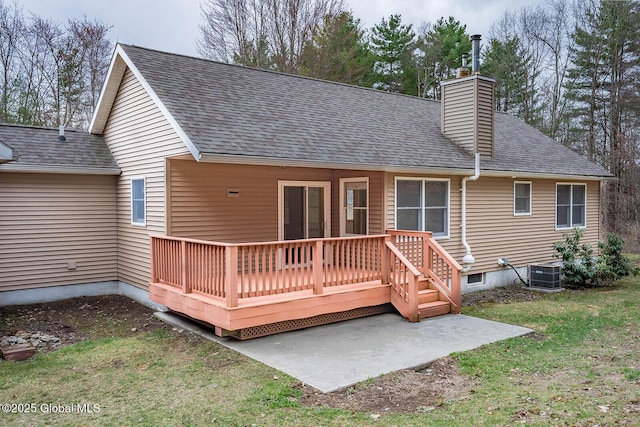 back of property featuring a chimney, a shingled roof, cooling unit, a patio area, and a deck