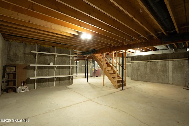 unfinished basement with heating unit and stairs