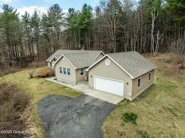 drone / aerial view with a wooded view