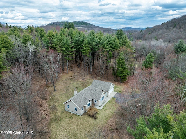 aerial view with a mountain view and a wooded view