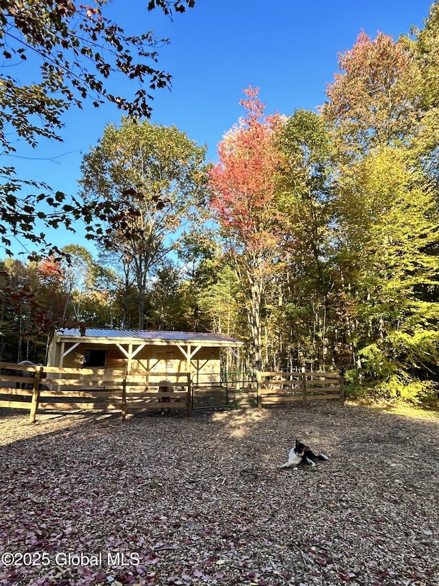 view of yard with an outdoor structure and fence
