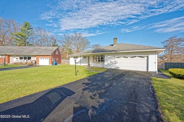31 Tryon Ct, Albany, NY 12203 - ranch-style house with a front lawn, a chimney, fence, an attached garage, and aphalt driveway