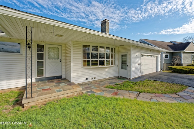 31 Tryon Ct, Albany, NY 12203 - view of front of house featuring an attached garage, a chimney, and aphalt driveway