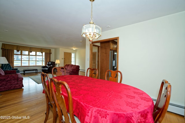 31 Tryon Ct, Albany, NY 12203 - dining space with a baseboard radiator, a chandelier, and light wood-style floors
