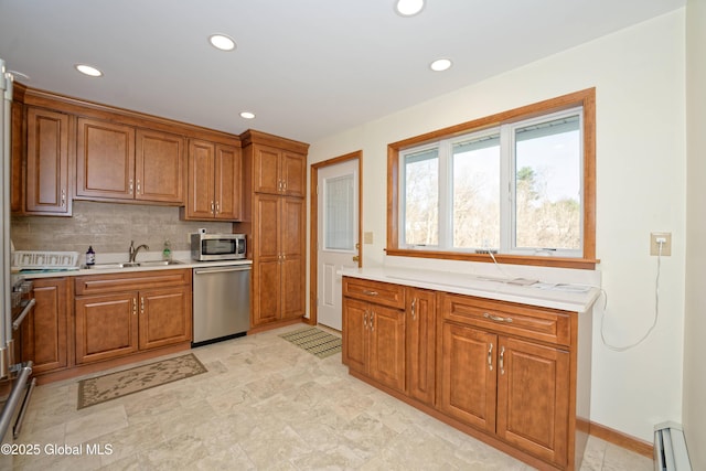 31 Tryon Ct, Albany, NY 12203 - kitchen with light countertops, a sink, a baseboard radiator, brown cabinetry, and appliances with stainless steel finishes