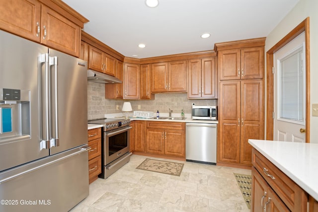 31 Tryon Ct, Albany, NY 12203 - kitchen with light countertops, brown cabinetry, appliances with stainless steel finishes, and under cabinet range hood