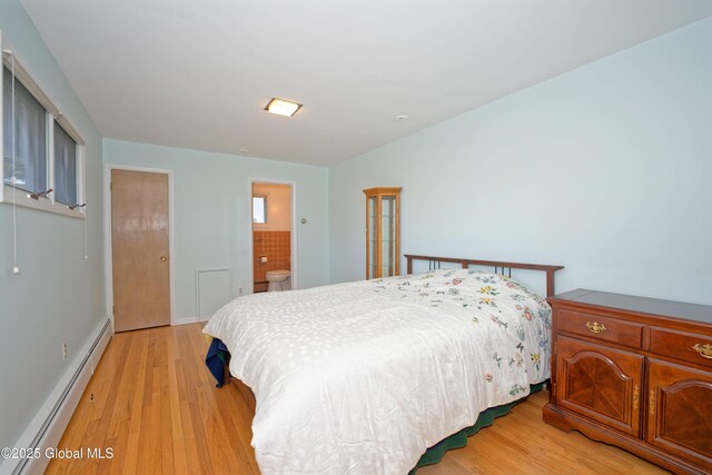 31 Tryon Ct, Albany, NY 12203 - bedroom with baseboard heating, baseboards, ensuite bathroom, and light wood-type flooring