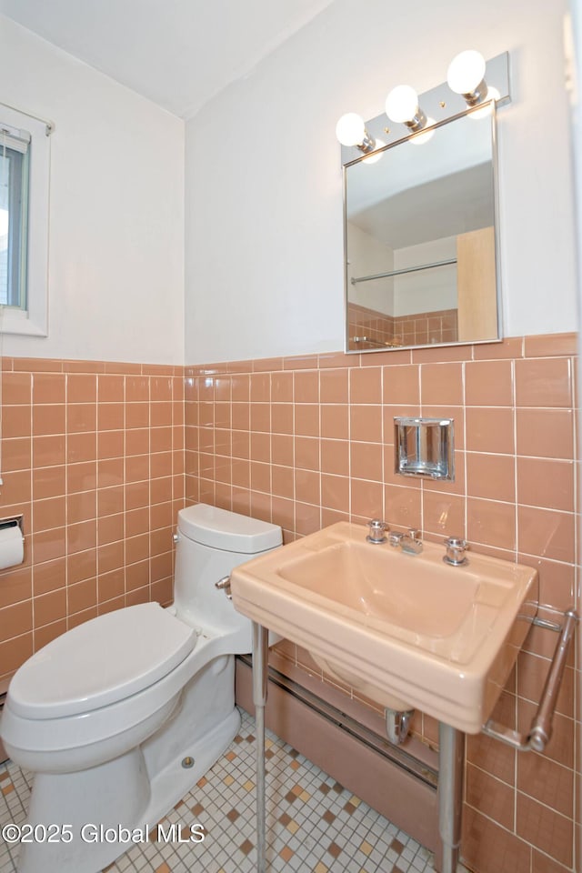 31 Tryon Ct, Albany, NY 12203 - bathroom featuring tile patterned flooring, tile walls, toilet, and a wainscoted wall