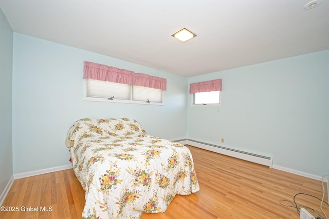 31 Tryon Ct, Albany, NY 12203 - bedroom featuring a baseboard radiator, baseboards, and wood finished floors