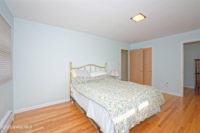 31 Tryon Ct, Albany, NY 12203 - bedroom featuring a baseboard heating unit, wood finished floors, and baseboards