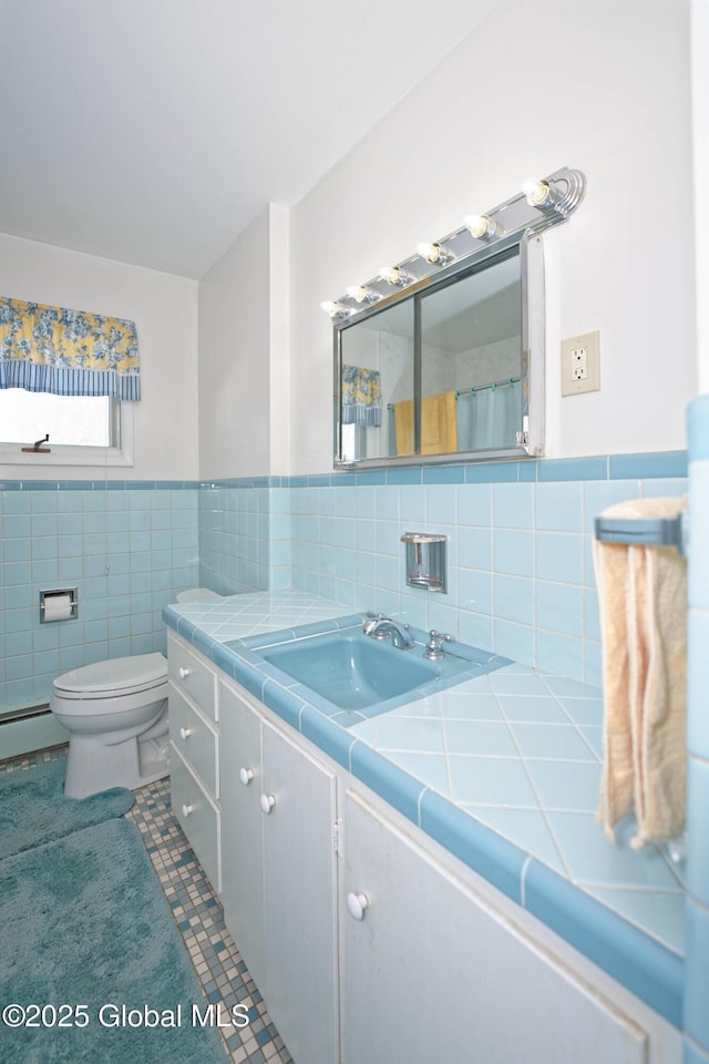 31 Tryon Ct, Albany, NY 12203 - full bathroom with tile patterned flooring, a wainscoted wall, toilet, vanity, and tile walls