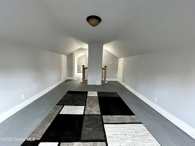 bonus room with baseboards, wood finished floors, and lofted ceiling