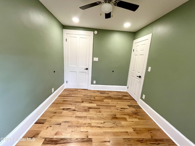 interior space with light wood-type flooring, baseboards, a ceiling fan, and recessed lighting