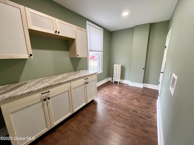 interior space with dark wood-type flooring, baseboards, recessed lighting, and radiator