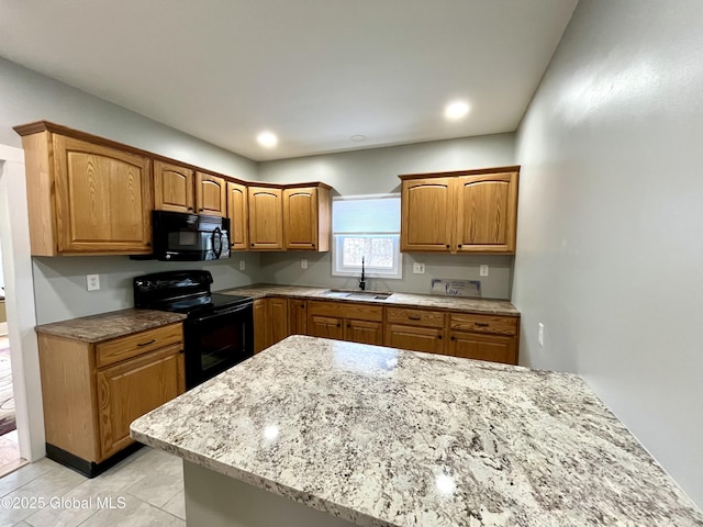 kitchen featuring a sink, brown cabinetry, black appliances, light tile patterned flooring, and light stone counters