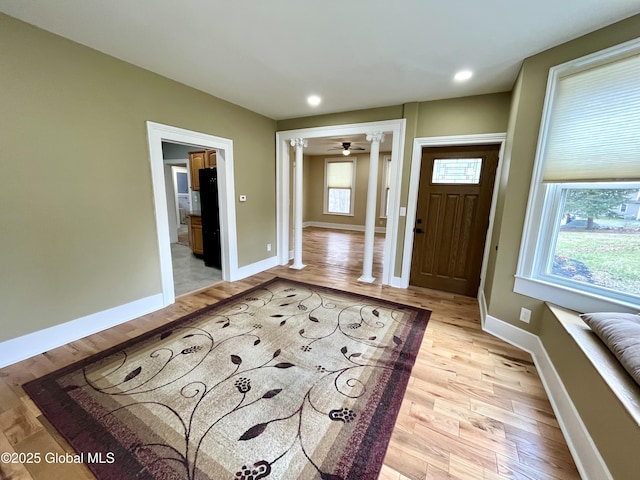 foyer with light wood-style flooring, ornate columns, baseboards, and recessed lighting