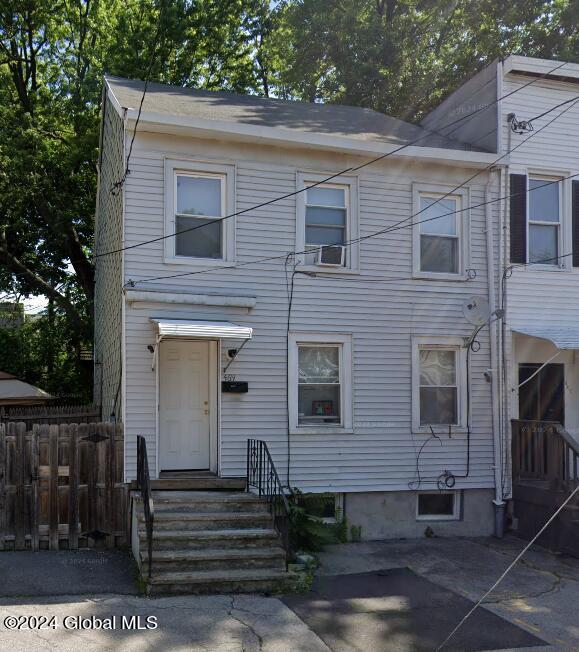view of front of home featuring fence