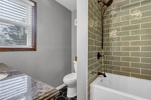 full bathroom featuring shower / tub combination, tile patterned flooring, vanity, toilet, and baseboards