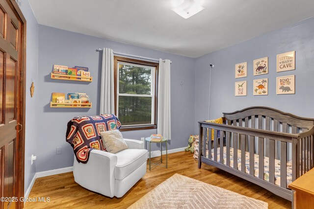 bedroom featuring baseboards and wood finished floors