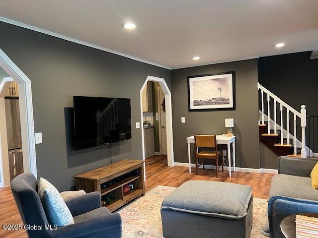 living room with recessed lighting, ornamental molding, stairs, and wood finished floors
