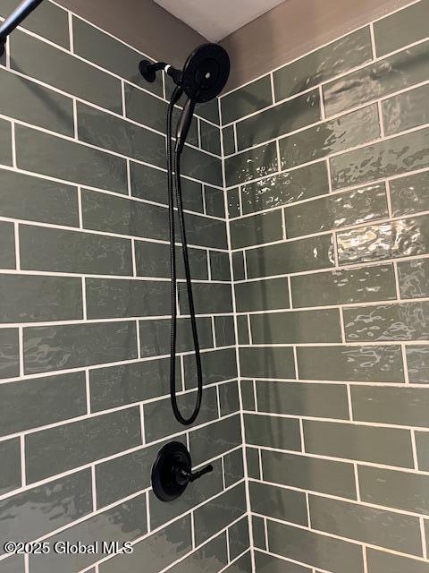 bathroom with a tile shower
