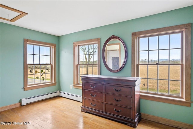interior space with light wood finished floors, baseboards, and multiple windows