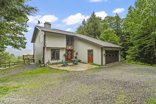 66 Schaeffer Rd, Berlin, NY 12138 - view of front of house featuring a chimney, driveway, a garage, an outdoor fire pit, and roof with shingles