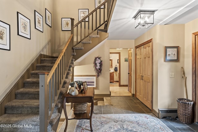 66 Schaeffer Rd, Berlin, NY 12138 - foyer entrance with stairs, a chandelier, and dark tile patterned flooring
