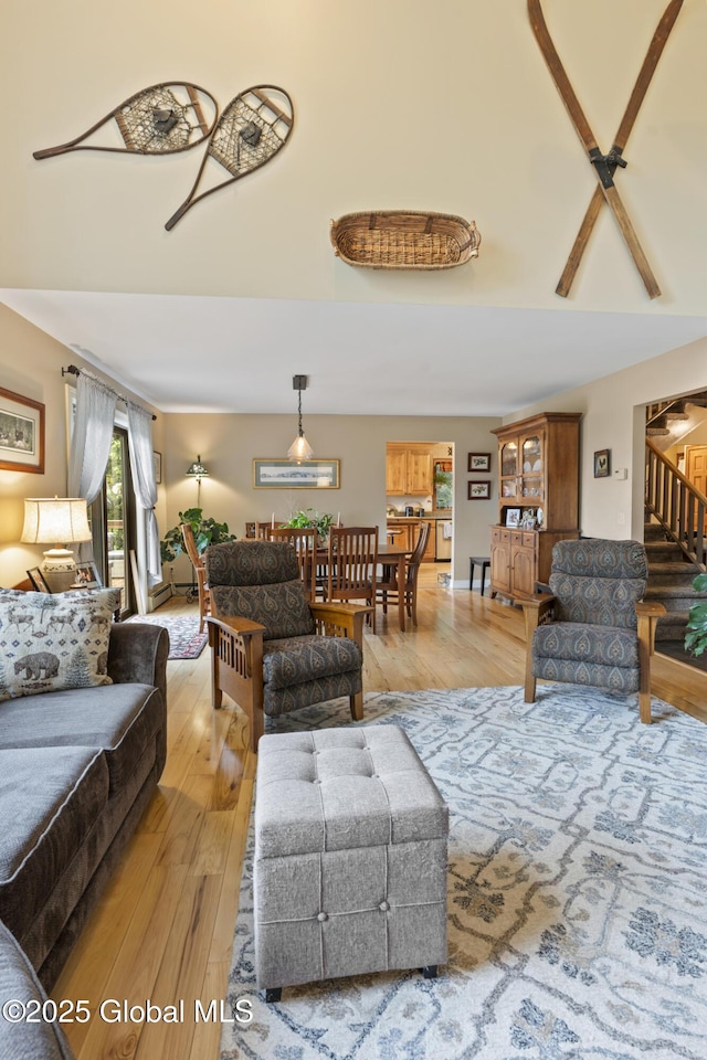 66 Schaeffer Rd, Berlin, NY 12138 - living area with light wood-style flooring, a high ceiling, and stairs