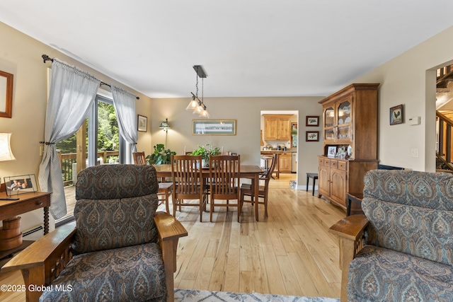 66 Schaeffer Rd, Berlin, NY 12138 - living room with light wood finished floors, a baseboard heating unit, and stairs