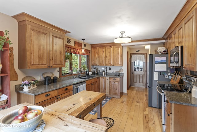 66 Schaeffer Rd, Berlin, NY 12138 - kitchen with stainless steel appliances, dark stone counters, brown cabinets, and light wood-type flooring