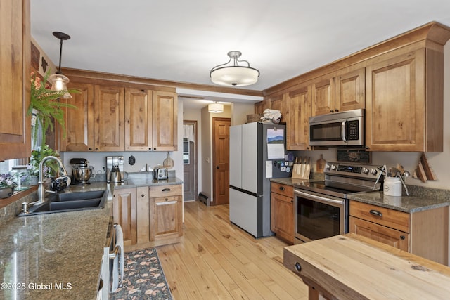 66 Schaeffer Rd, Berlin, NY 12138 - kitchen with stainless steel appliances, hanging light fixtures, light wood-style flooring, and dark stone countertops
