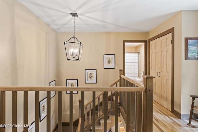 66 Schaeffer Rd, Berlin, NY 12138 - corridor with an upstairs landing, a chandelier, and wood finished floors