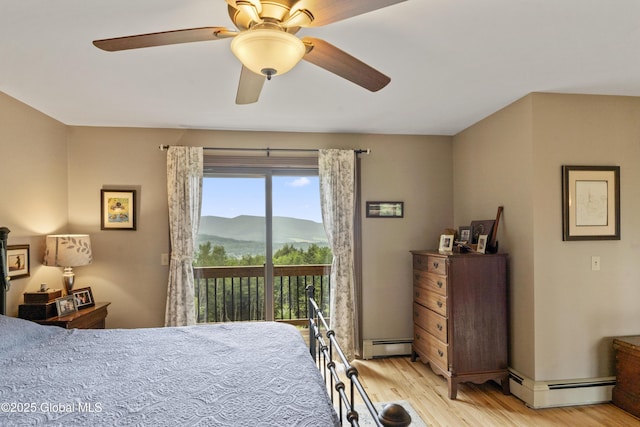 66 Schaeffer Rd, Berlin, NY 12138 - bedroom featuring a baseboard radiator, access to outside, a mountain view, light wood-style floors, and ceiling fan