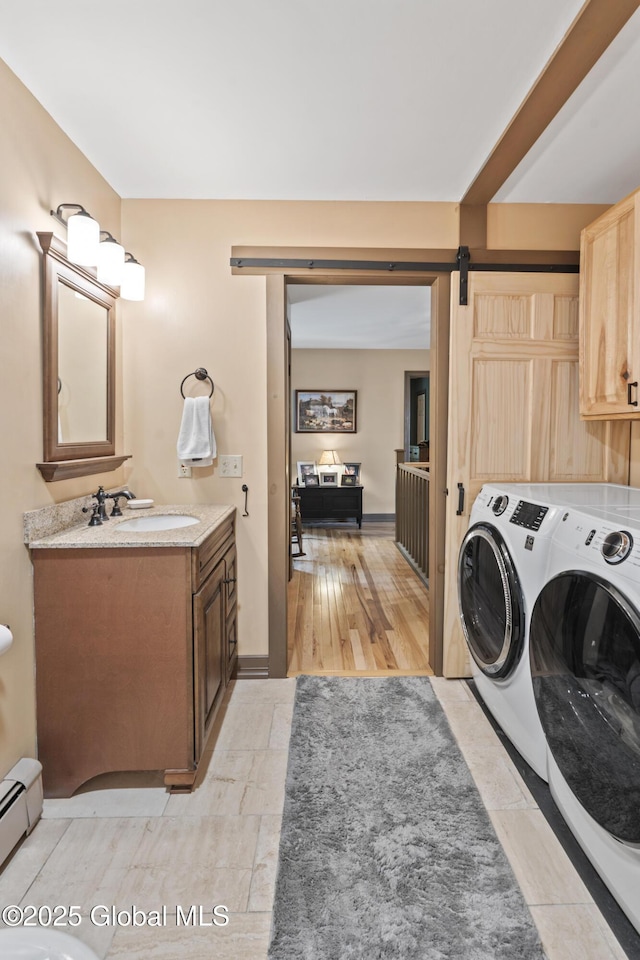 66 Schaeffer Rd, Berlin, NY 12138 - laundry area with independent washer and dryer, baseboard heating, and a barn door