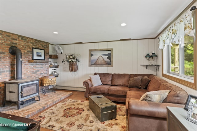 66 Schaeffer Rd, Berlin, NY 12138 - living area with a baseboard heating unit, a wood stove, and wood finished floors