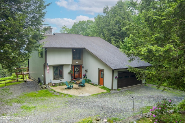 66 Schaeffer Rd, Berlin, NY 12138 - view of front of property featuring gravel driveway, roof with shingles, a garage, and a chimney