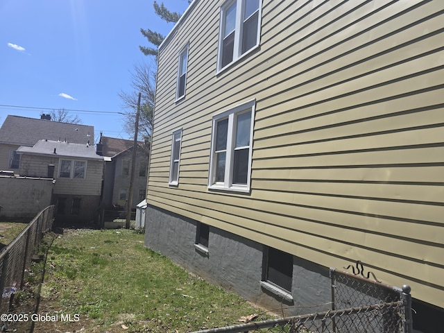 view of side of property featuring fence