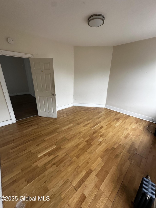 44 Storrie St, Amsterdam, NY 12010 - empty room with wood finished floors, a smoke detector, and baseboards
