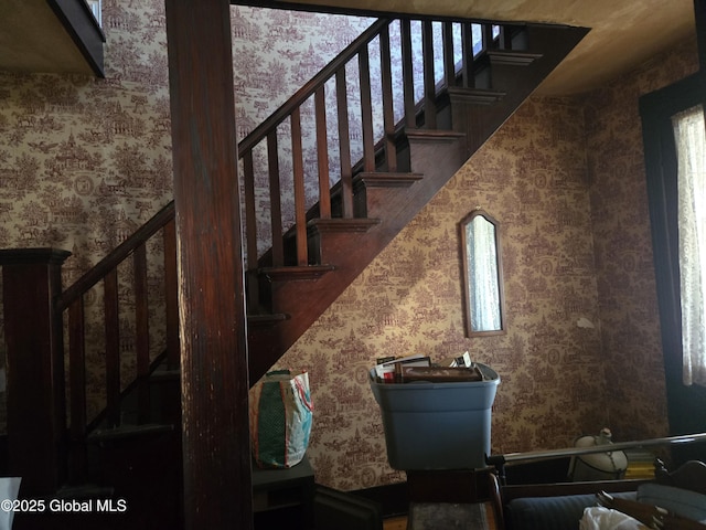staircase featuring wallpapered walls