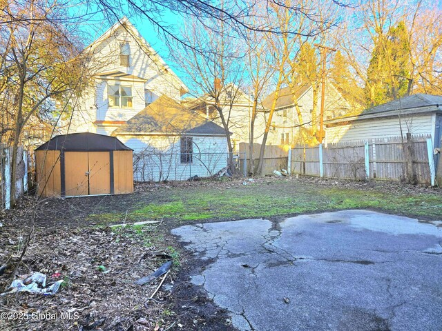 15 Kenyon Ct, Utica, NY 13501 - view of yard with a storage shed, fence, and an outdoor structure