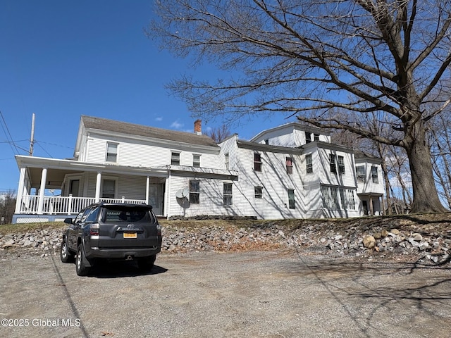 view of front of house with a porch and a chimney