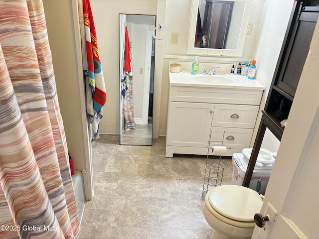 bathroom featuring toilet and vanity