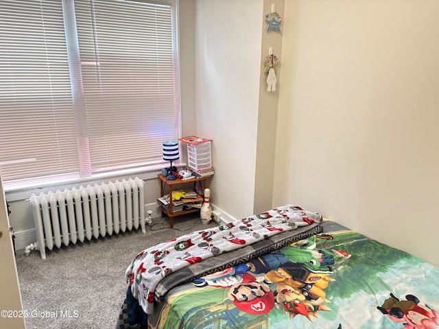 bedroom with radiator and carpet